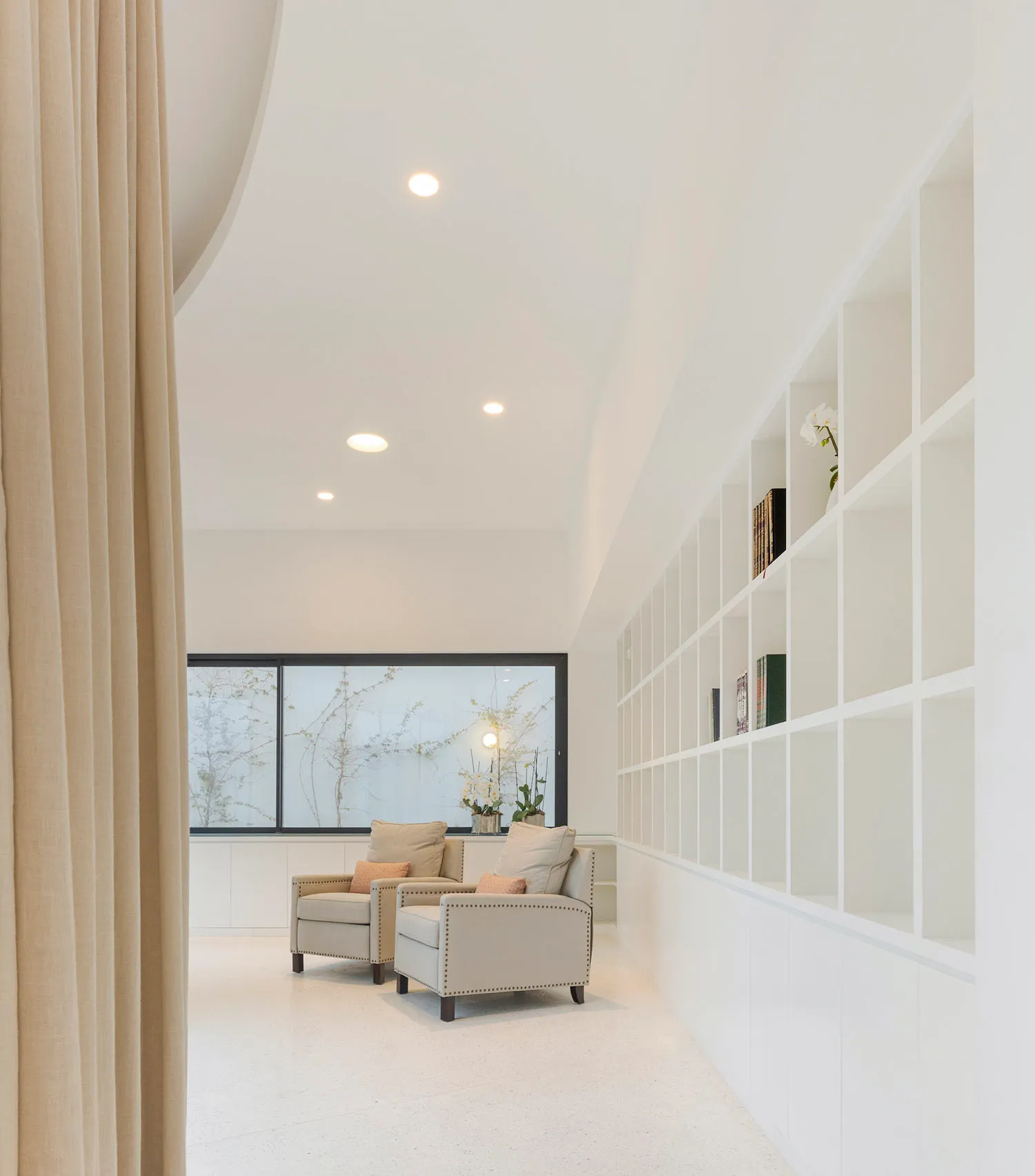 A modern living room featuring neutral-toned furniture and a minimalist design.