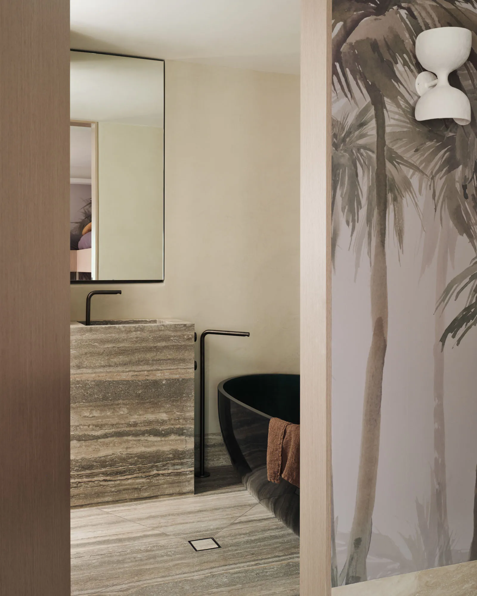 Modern bathroom with marble finishes and a palm tree mural.