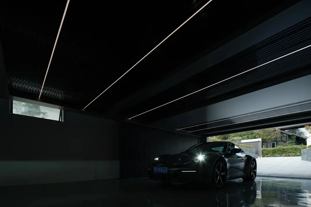 A sleek, metallic modern garage interior with a reflective floor and contemporary design elements.