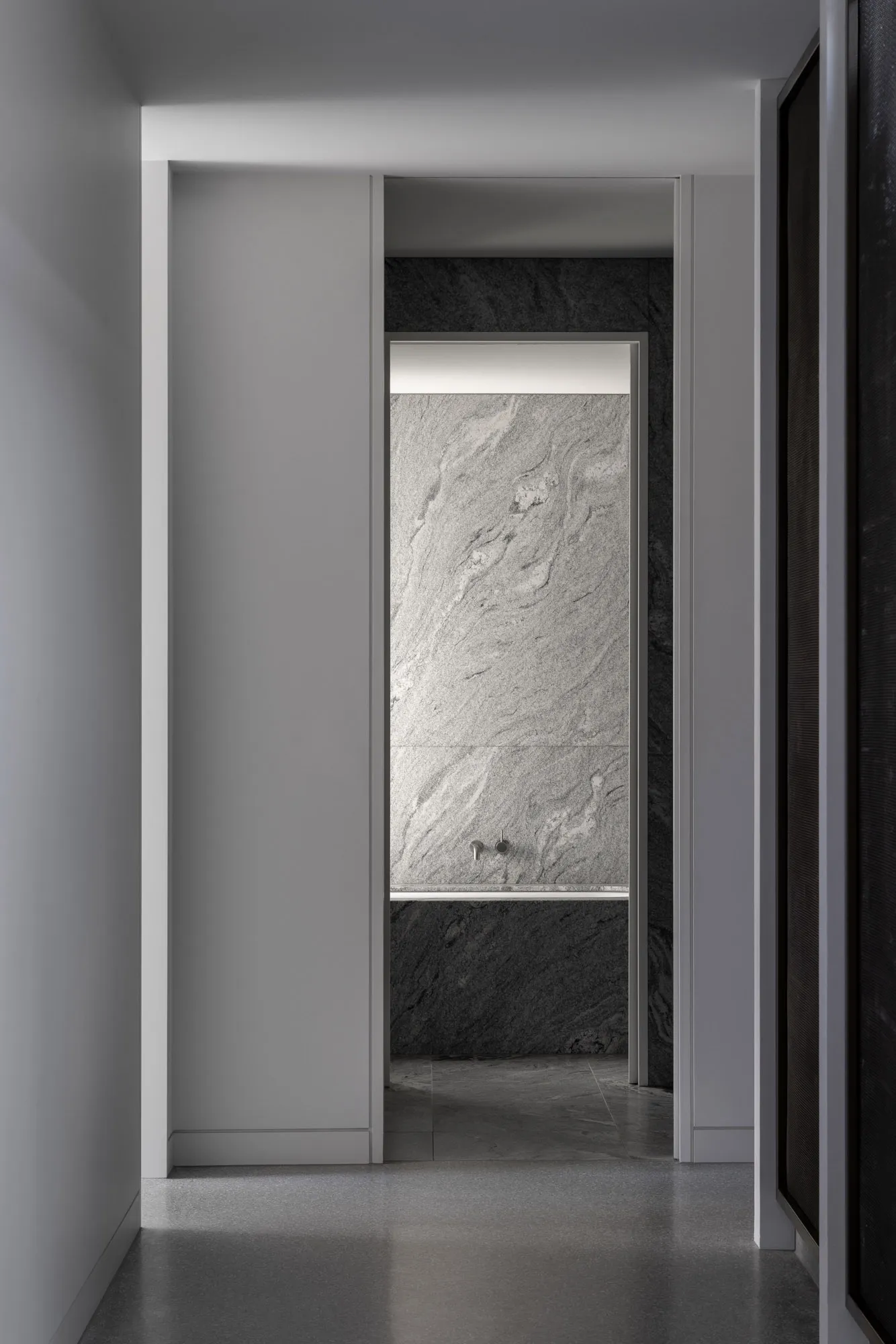 Modern minimalist interior design featuring marble walls and flooring
