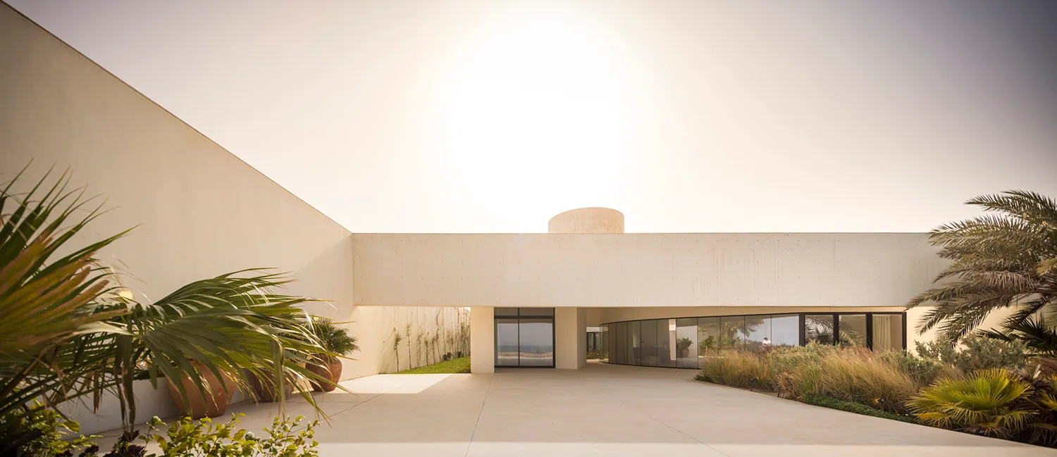 Modern residential exterior with minimalist design and concrete materials.