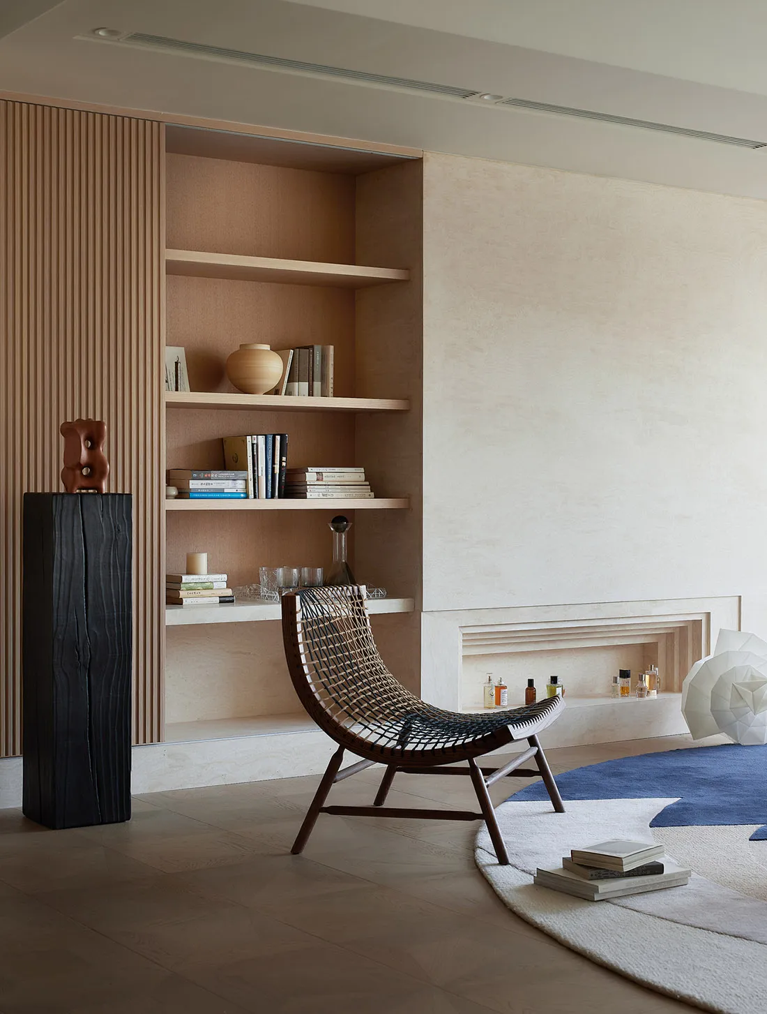 A modern residential interior featuring wood, leather, and ceramic elements.