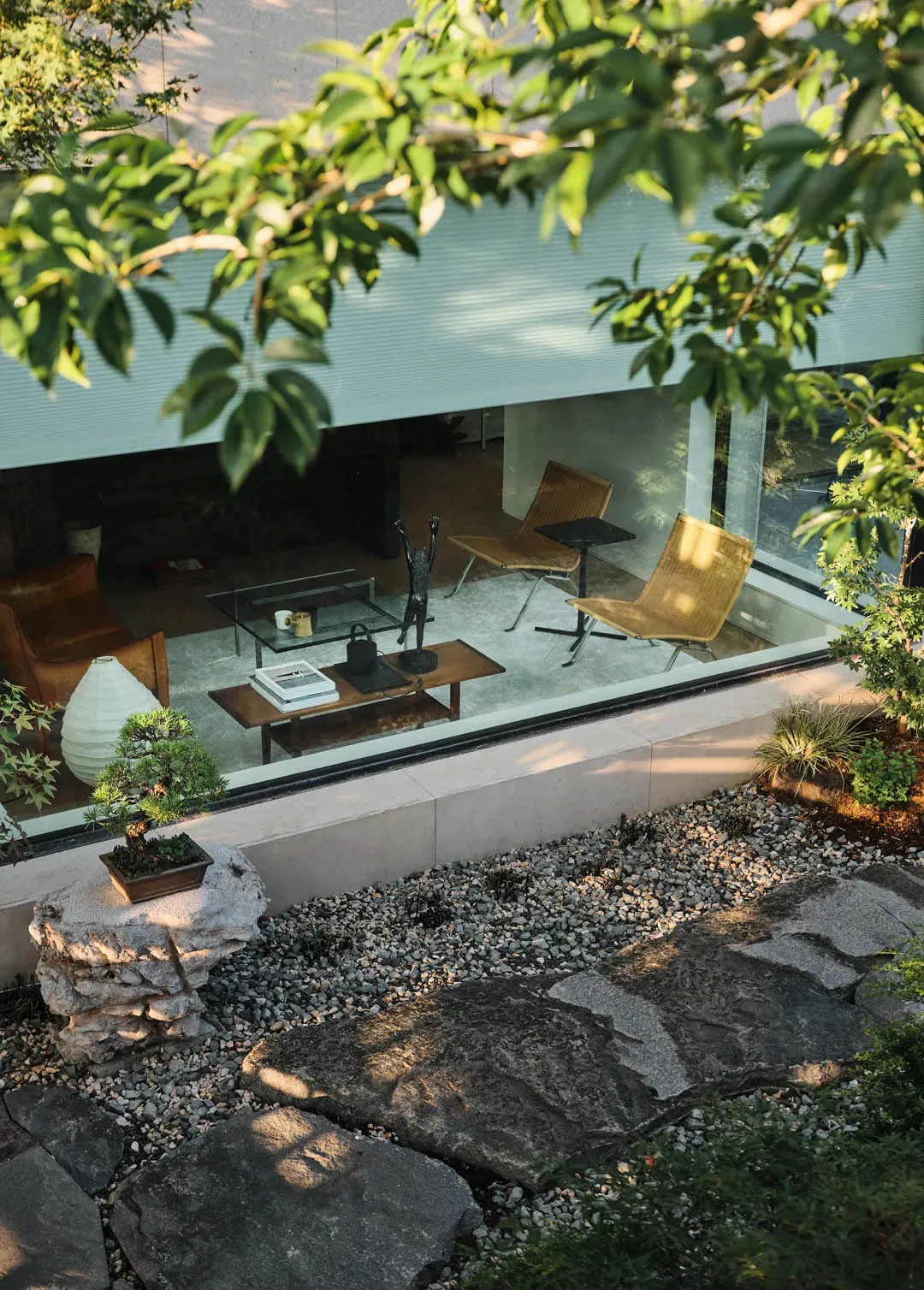 A modern living space featuring natural stone and minimalist furniture.