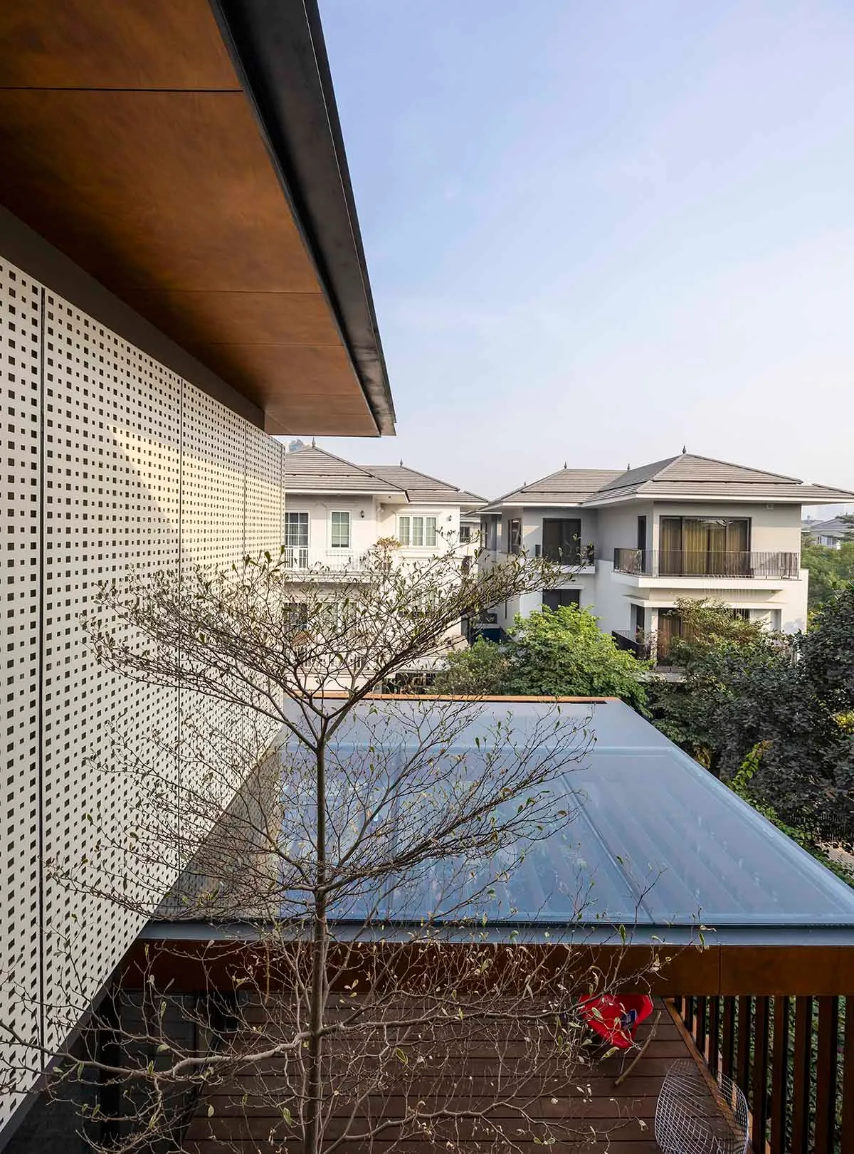 Modern house with metal exterior and tree in foreground