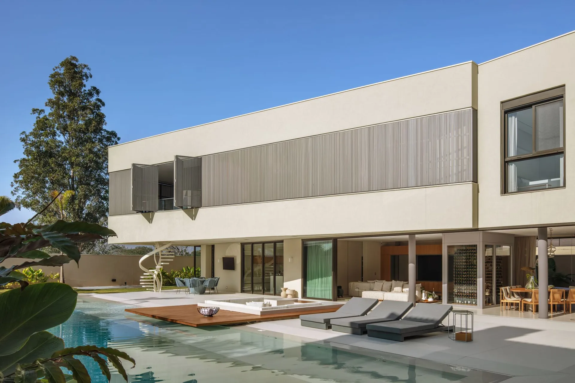 Modern residential home with concrete exterior and large open living space.