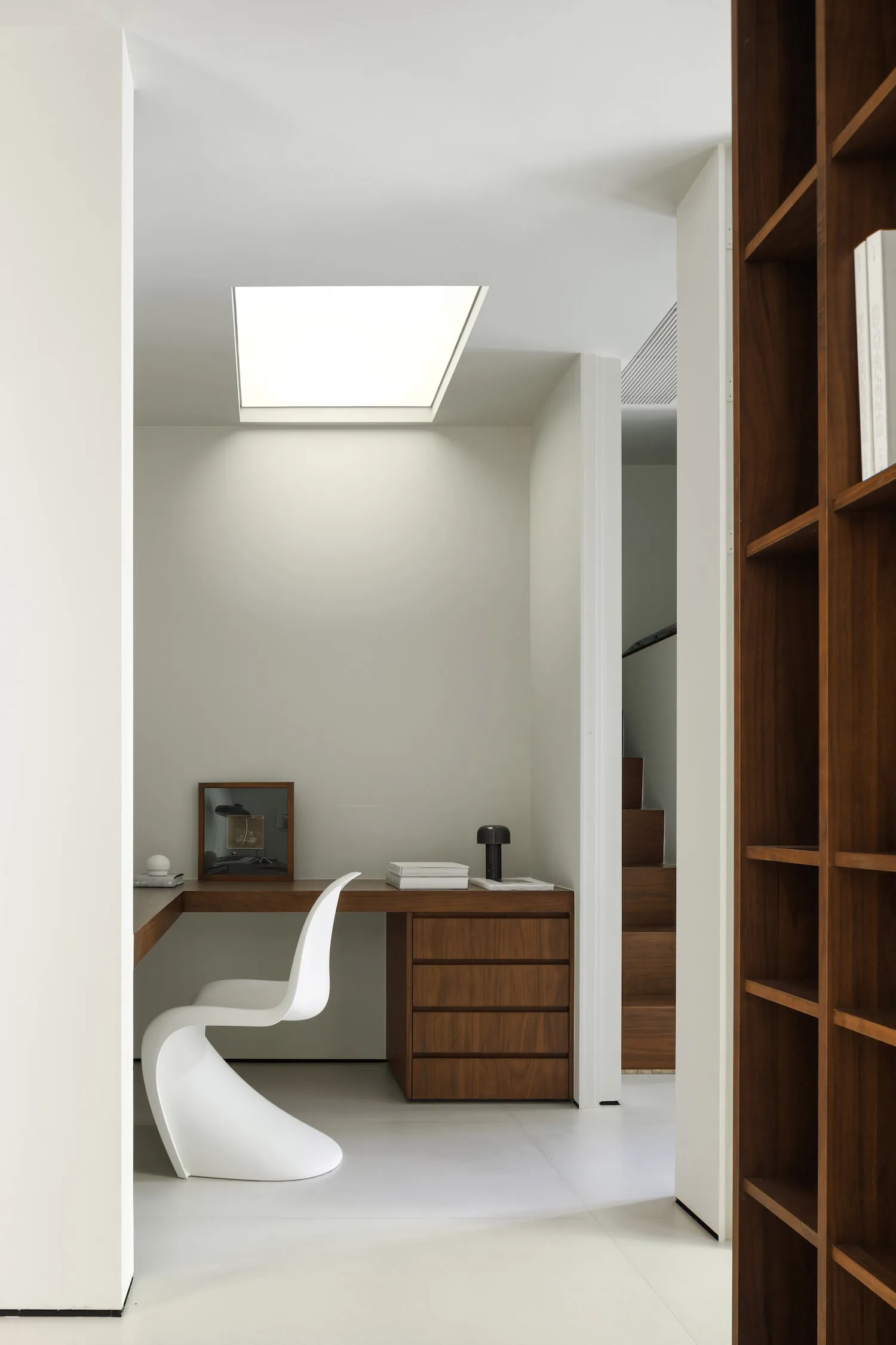 An image depicting a stylish, modern minimalist home office with wooden furniture