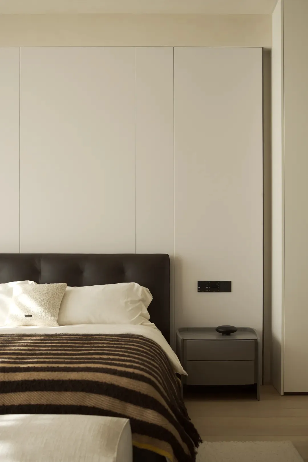 Modern bedroom with minimalist design, neutral tones, and clean lines.