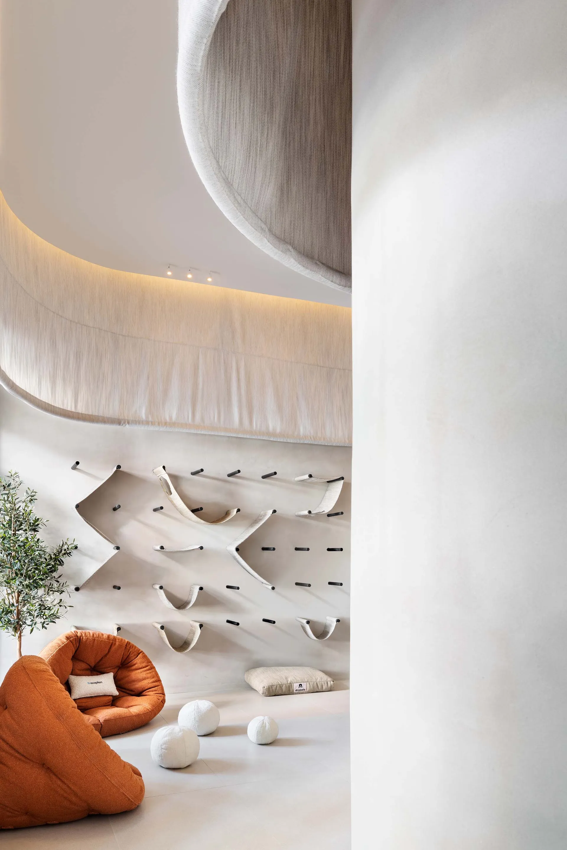 Modern minimalist living space with fabric elements and beige color palette.