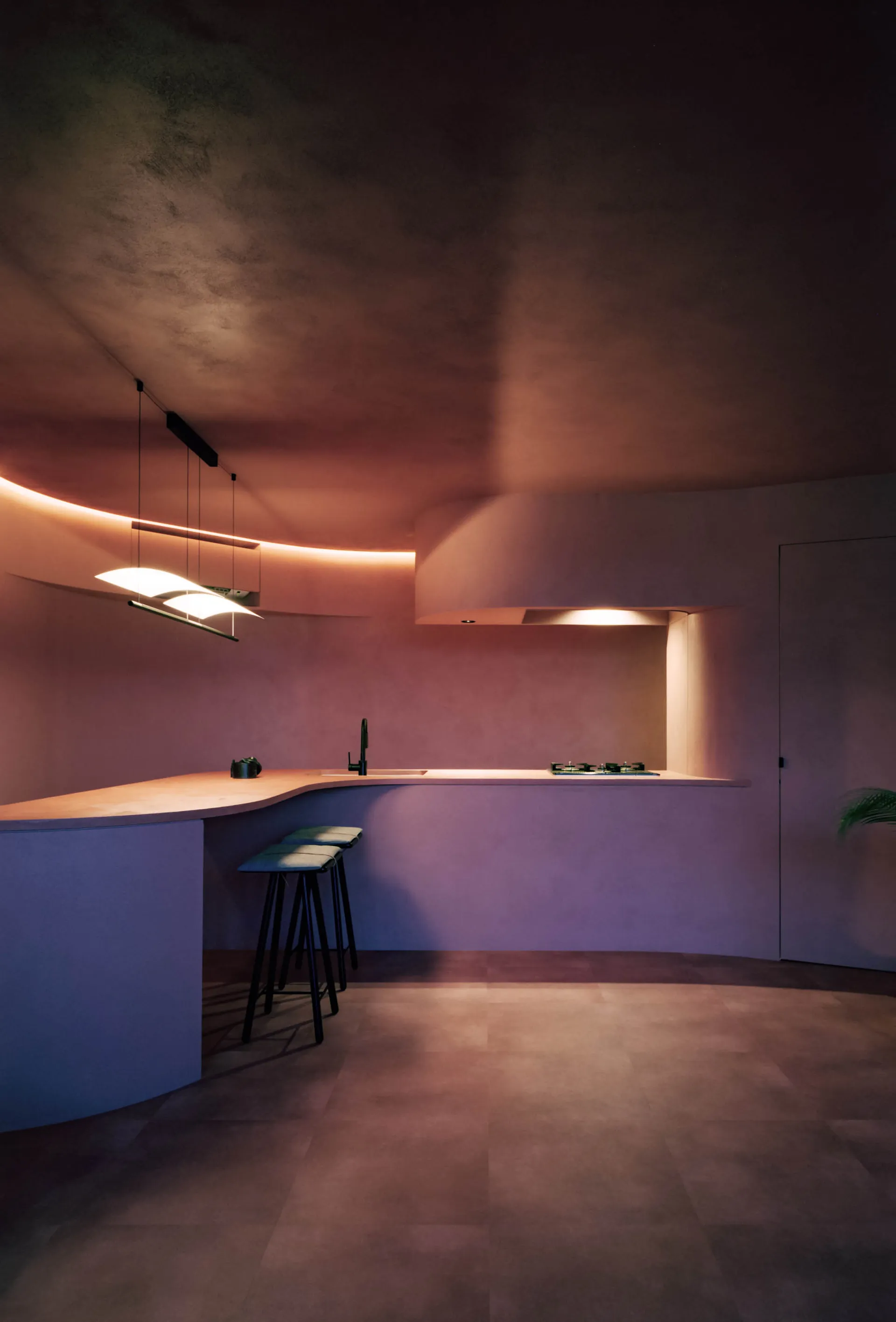A modern kitchen with concrete walls, minimalist design, and warm lighting.