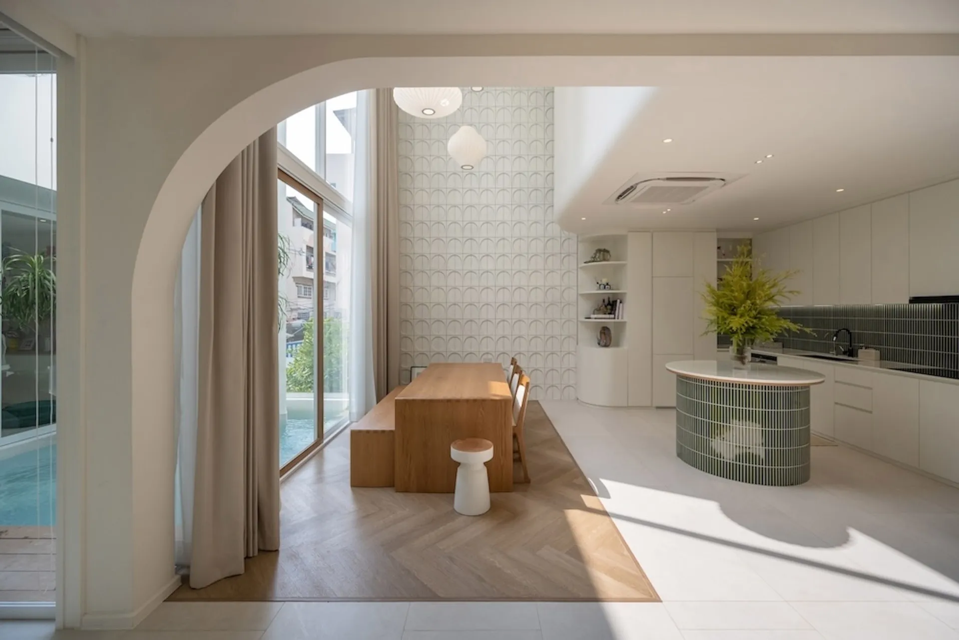 A modern kitchen with wooden countertops, glass cabinets, and tile backsplash.
