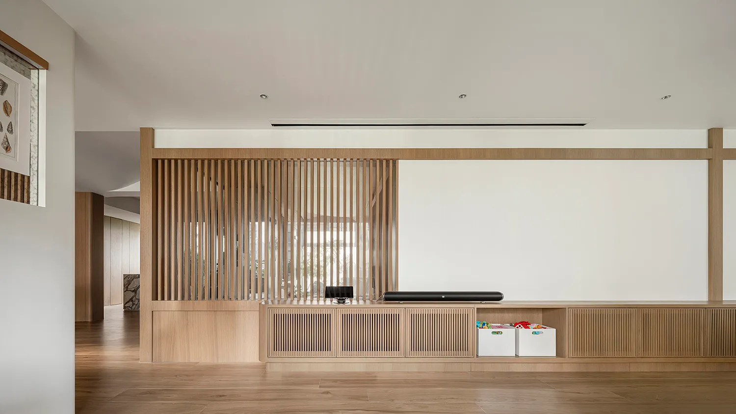 A modern minimalist living room featuring wooden paneling.