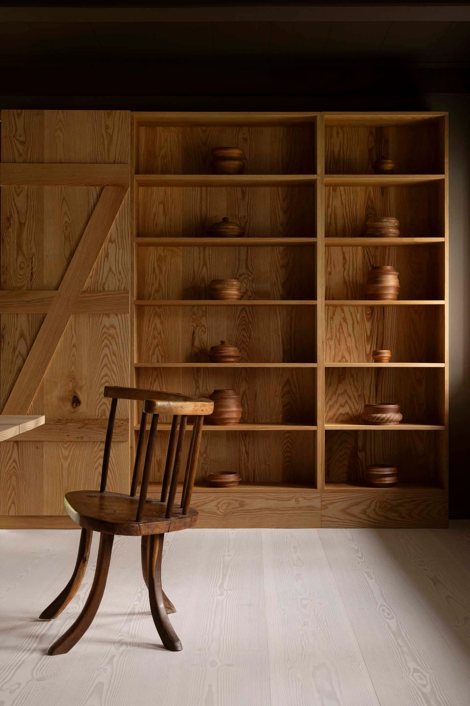 A minimalist living space featuring industrial design elements and wooden furniture.