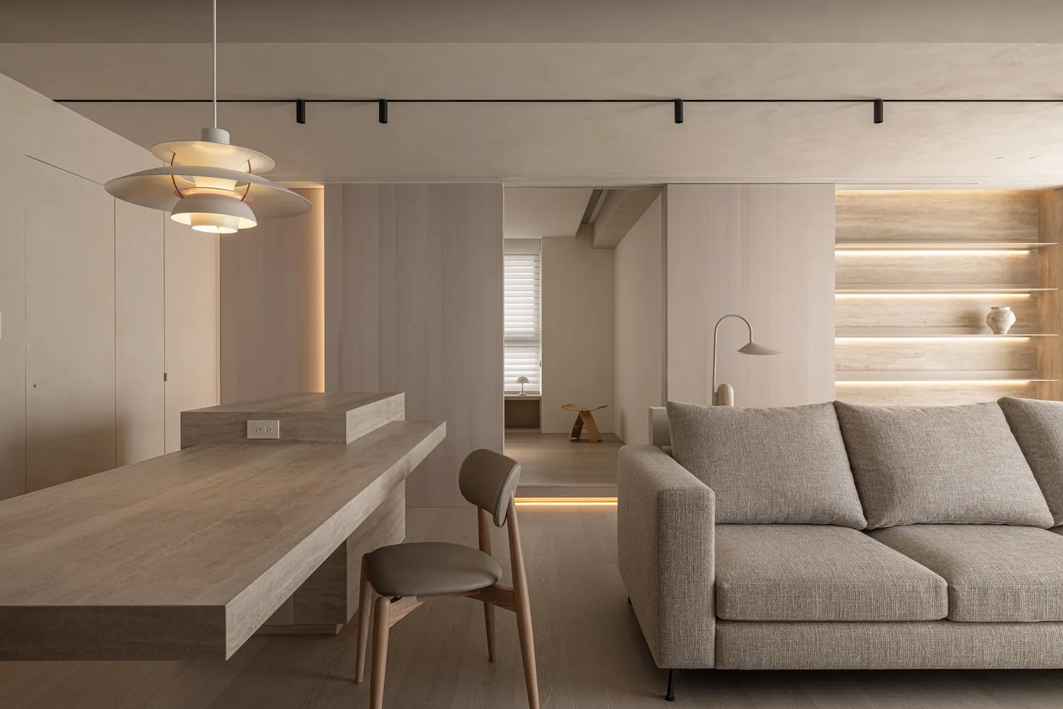 Modern minimalist living room featuring wood and leather furniture.