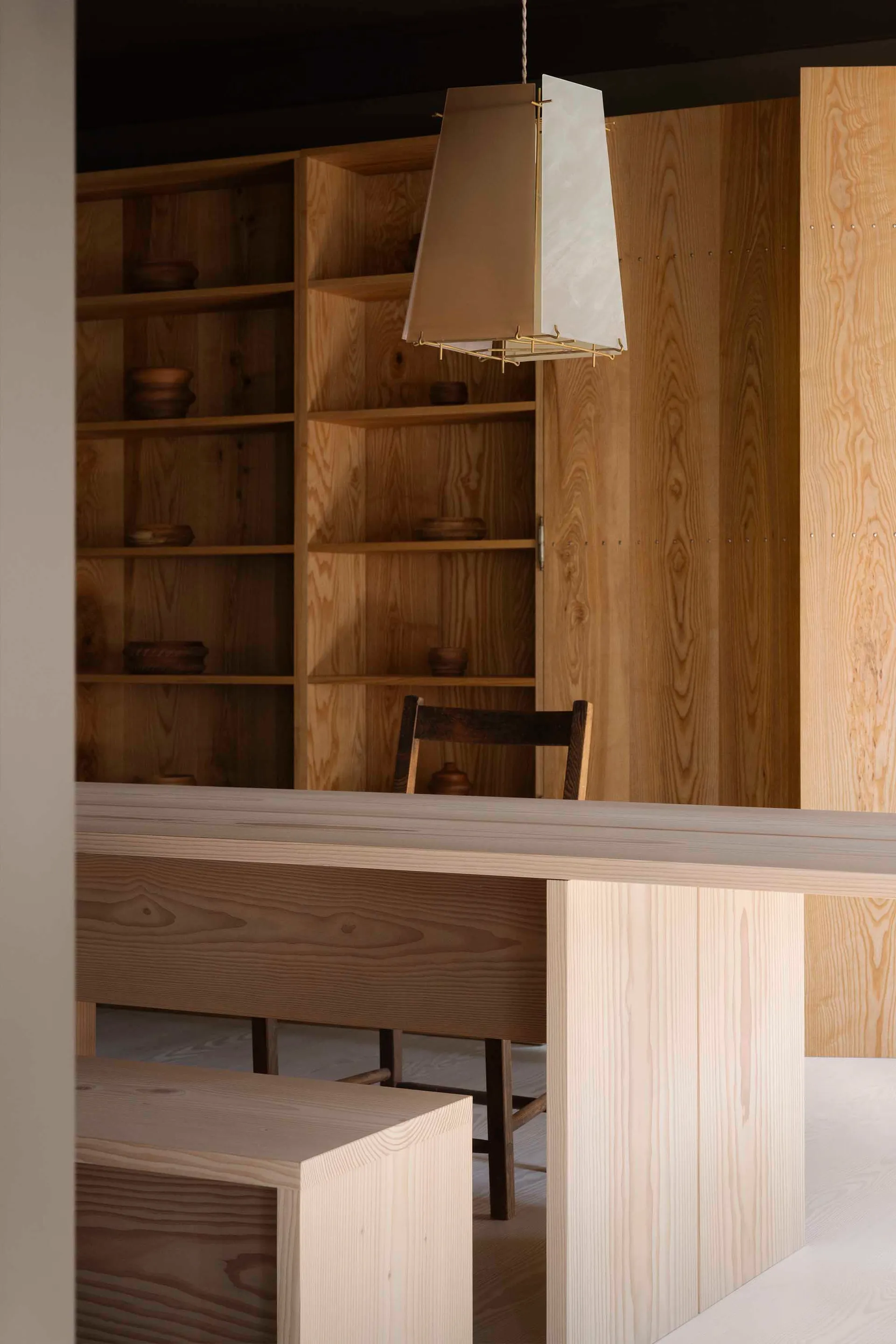Minimalist residential interior design featuring wooden furniture and materials.