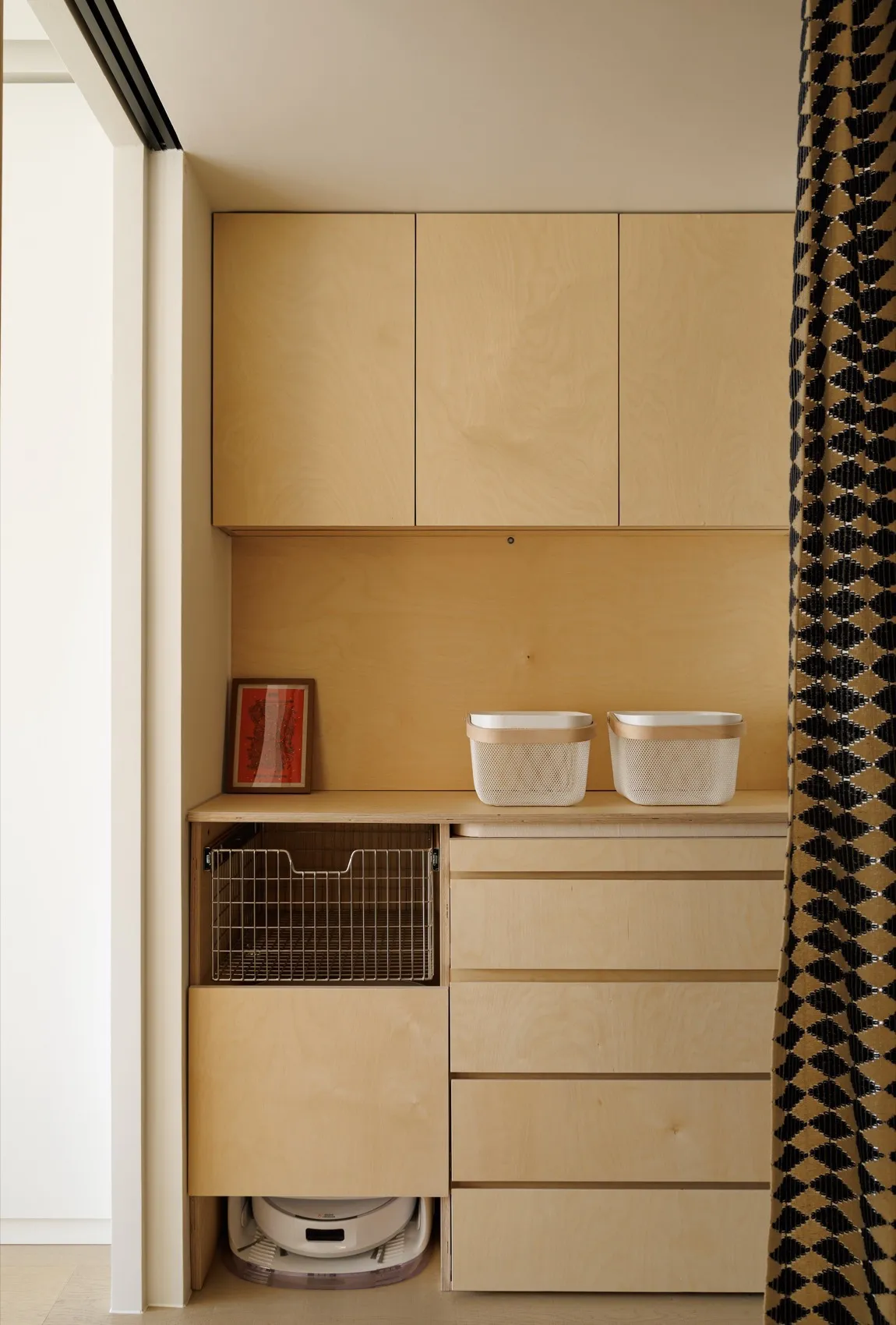 A modern wooden storage unit with cabinets and drawers, featuring a clean, minimalist design.