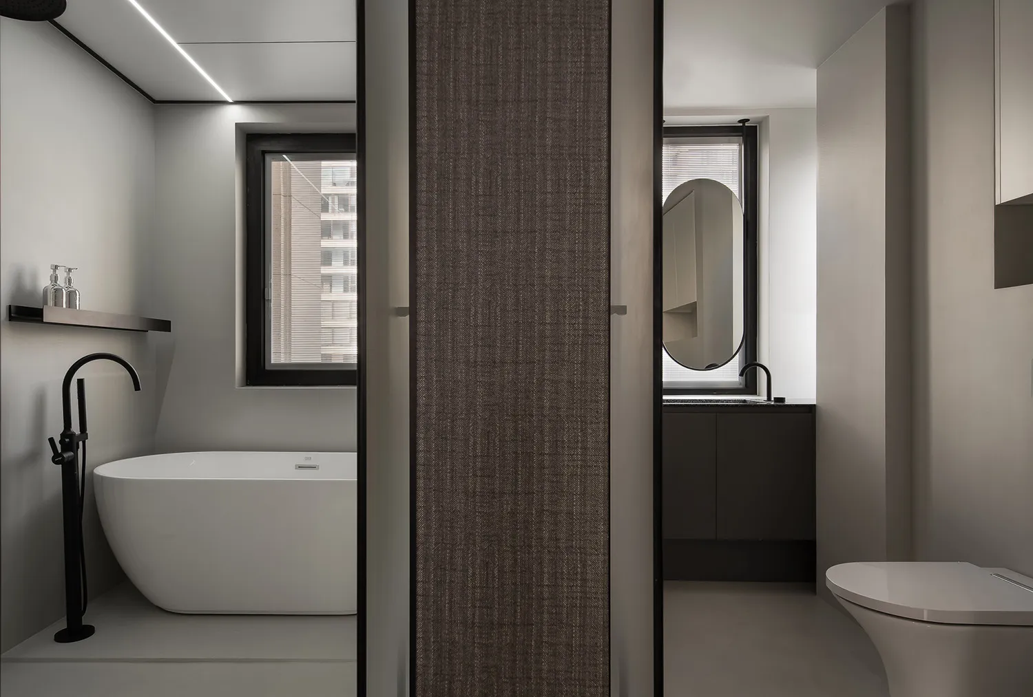 Modern bathroom featuring a concrete bathtub and minimalist design elements.