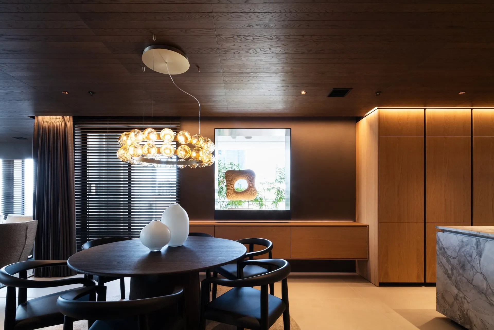 Modern dining room featuring wooden elements and minimalist design.