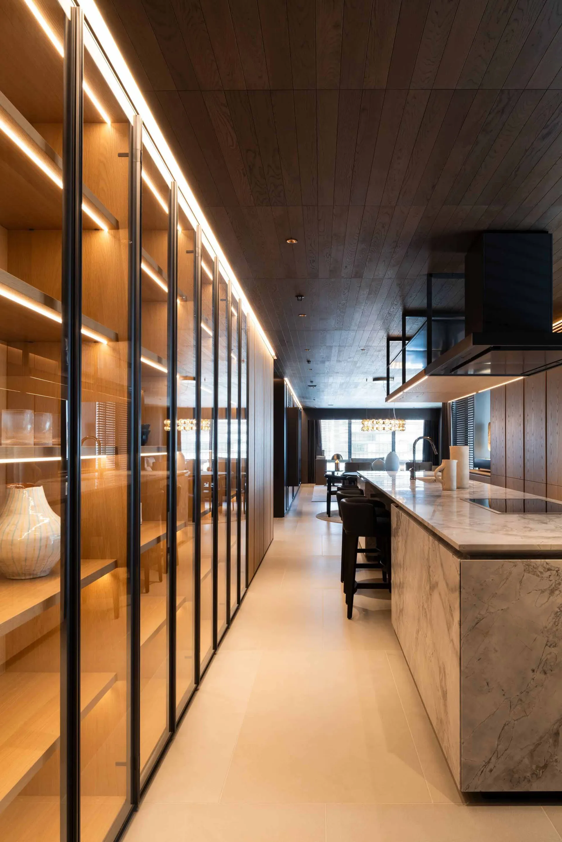 Modern kitchen featuring marble countertops and wooden cabinets.