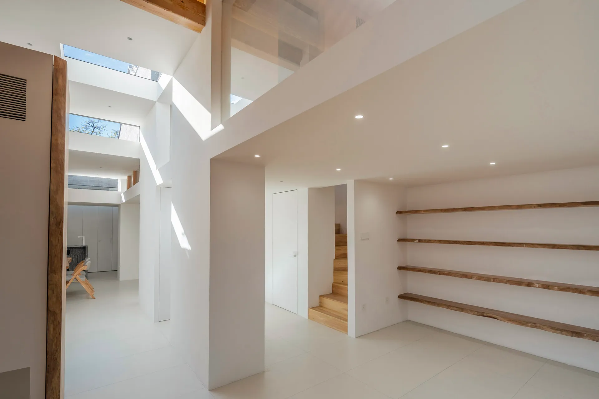 Modern staircase featuring concrete and wooden steps in a minimalist interior design setting.
