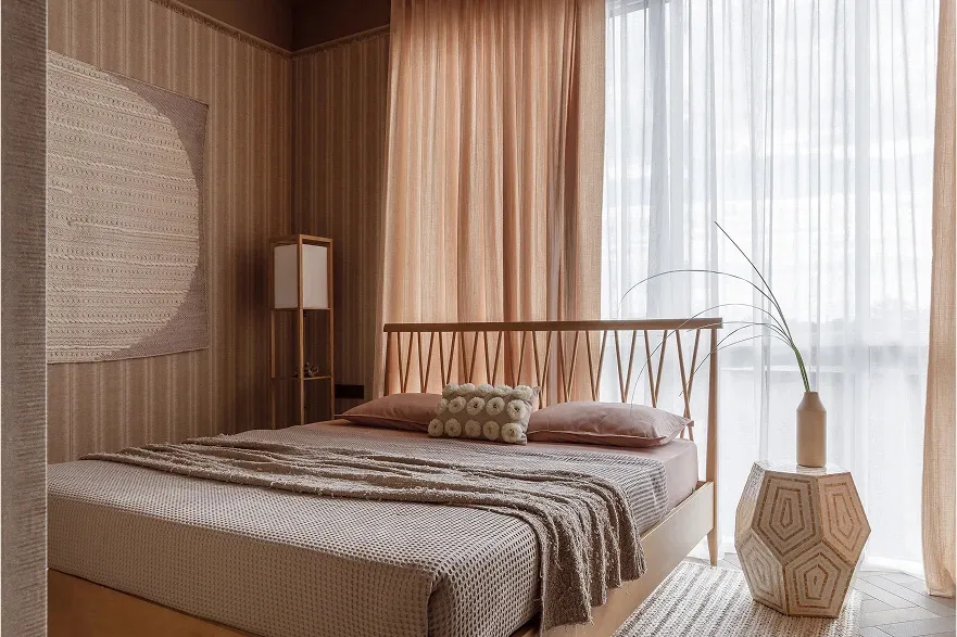 A modern minimalist bedroom with a wooden bed, beige curtains, and a large window.