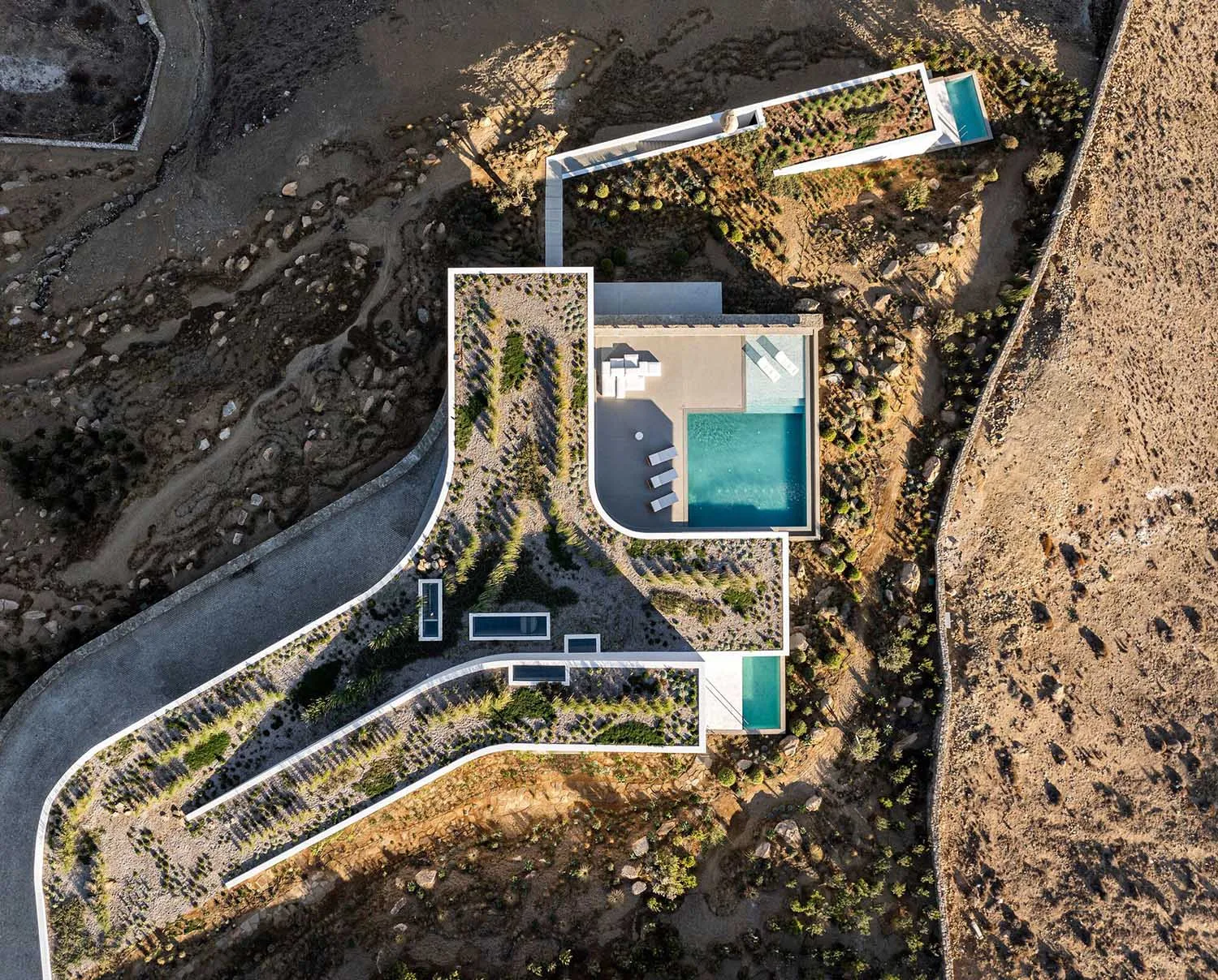 Aerial view of a modern residential architecture with concrete and glass materials.