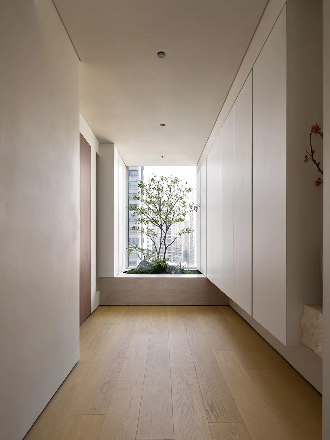 A modern interior space with white walls, hardwood flooring, and a minimalist design.