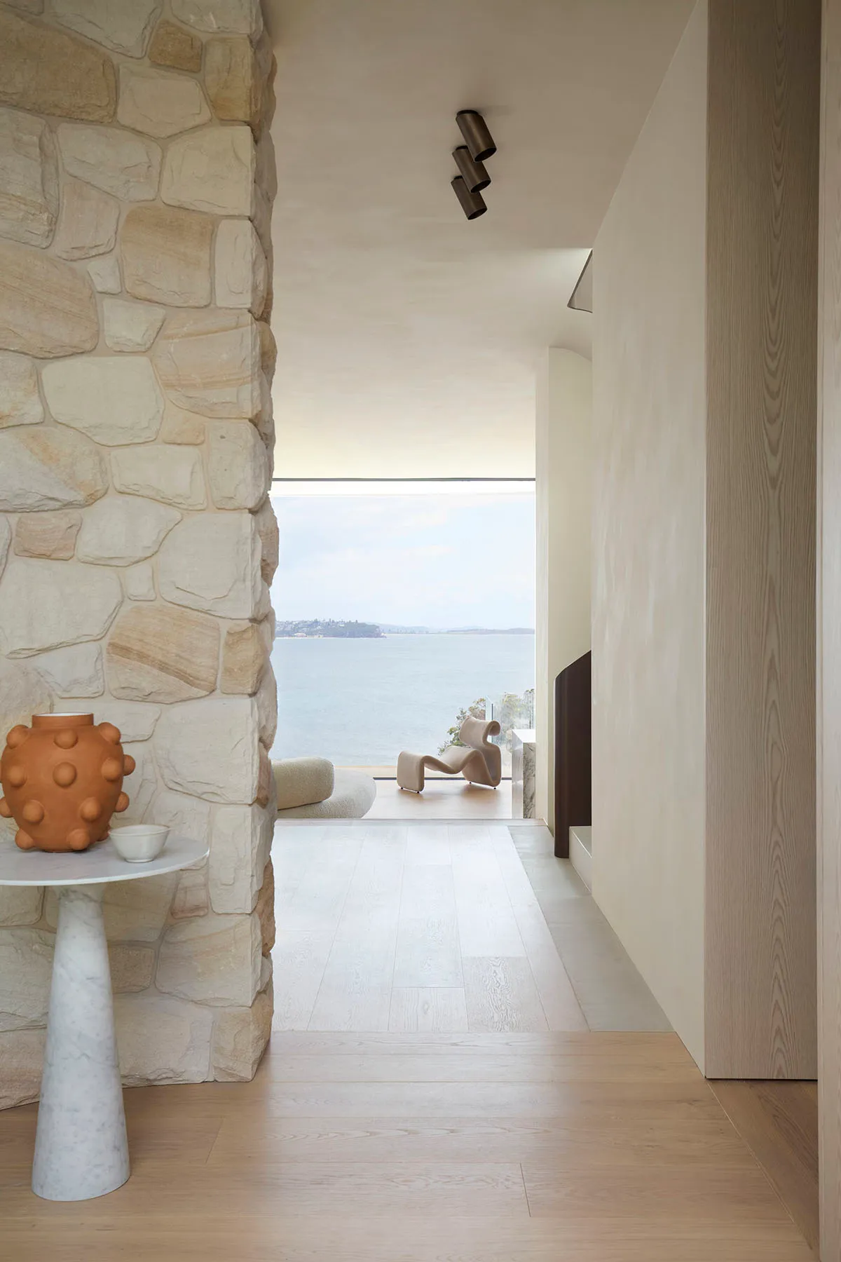 A modern residential space featuring stone and wood elements.