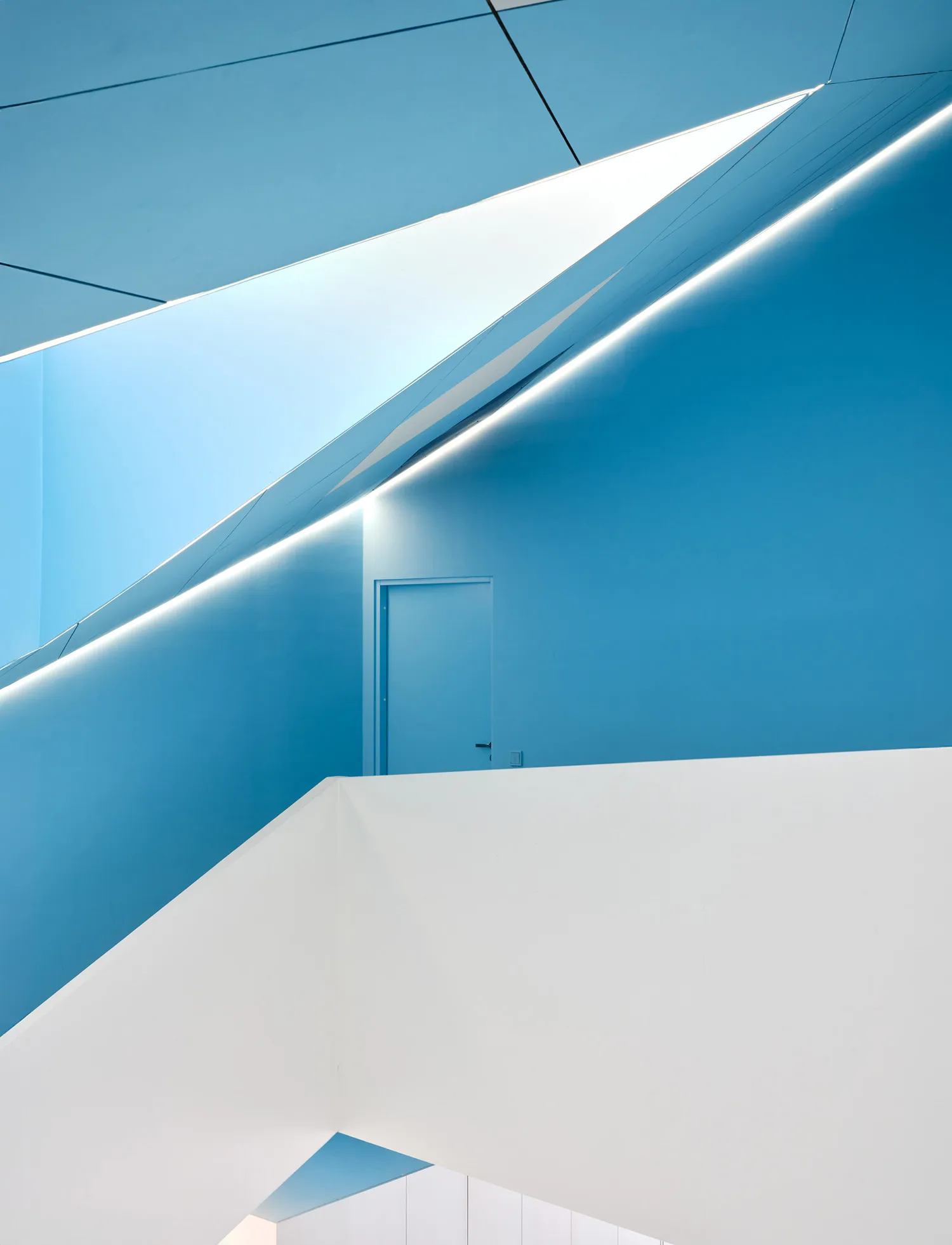 Blue and white geometric interior with concrete walls and minimalist design