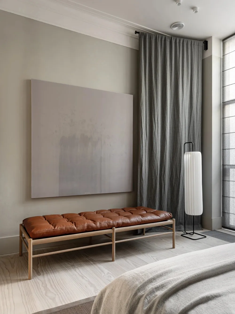 A minimalist bedroom featuring a comfortable sofa with plush cushions
