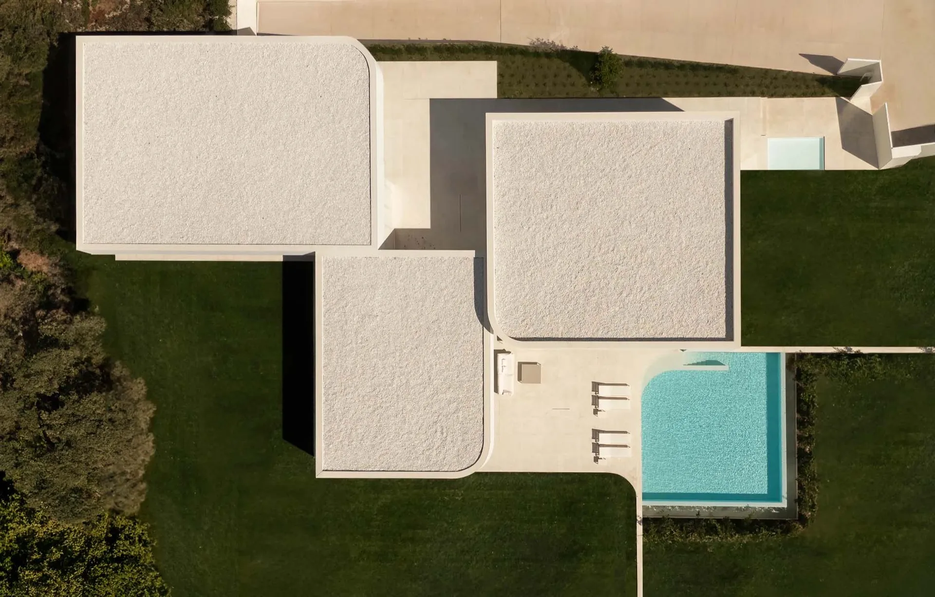 Aerial view of modern residential architecture featuring a concrete floor plan.