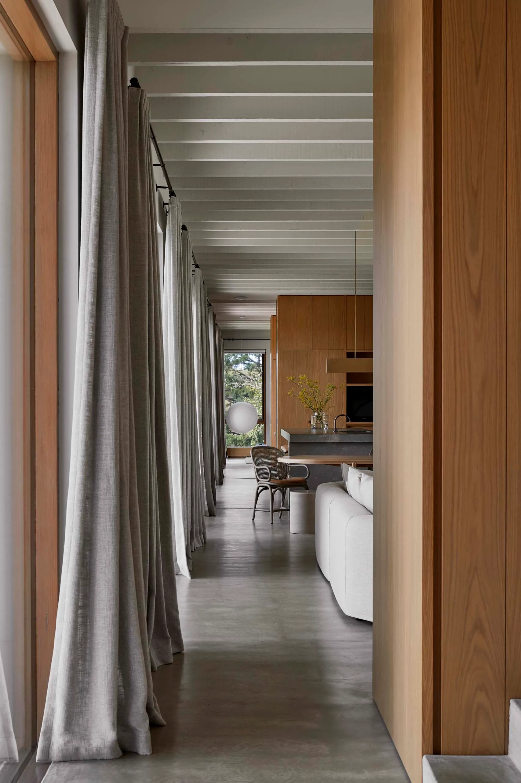 Modern residential interior featuring concrete flooring and wooden elements.