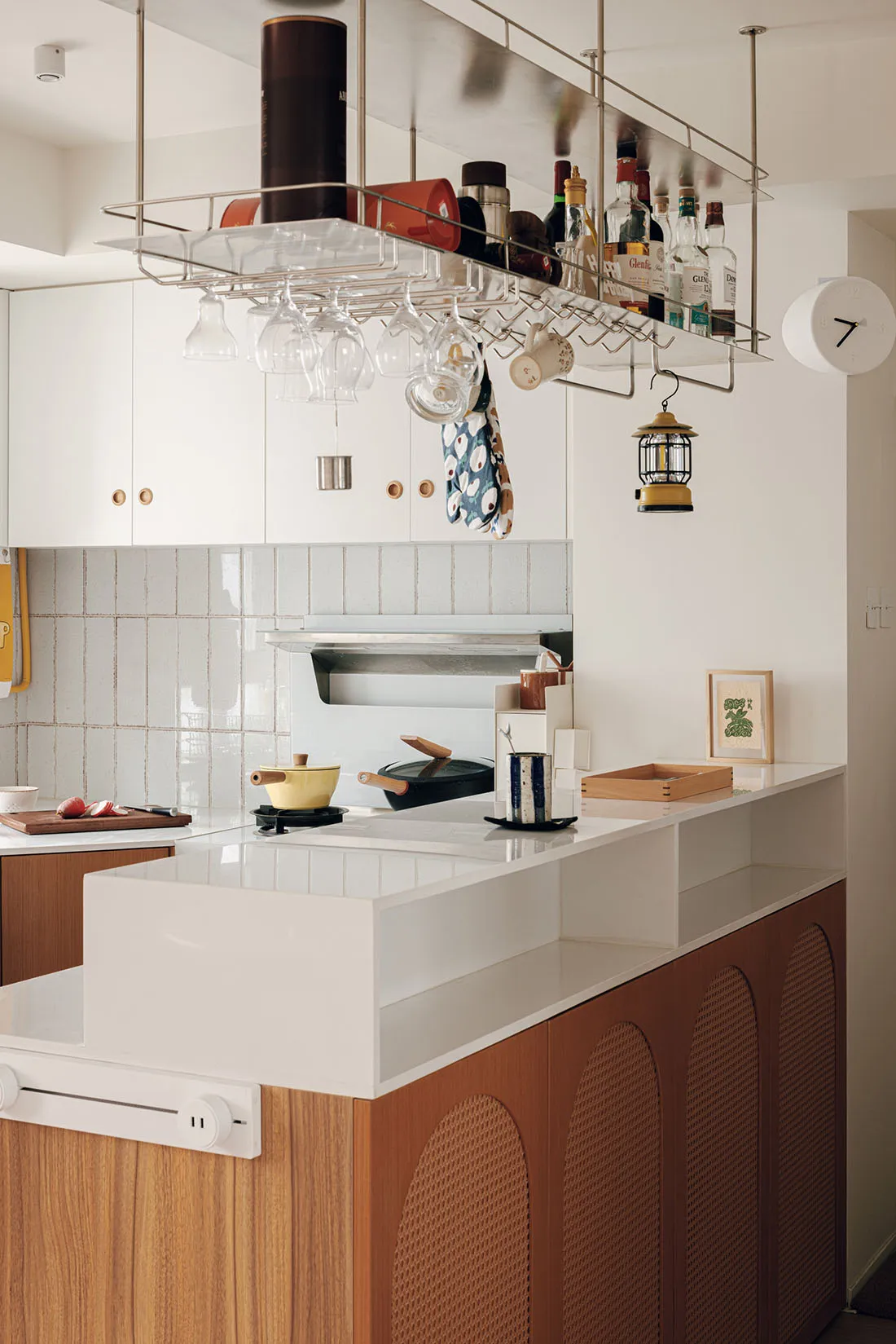 A modern residential kitchen with white countertops, wooden cabinets, and white backsplash.