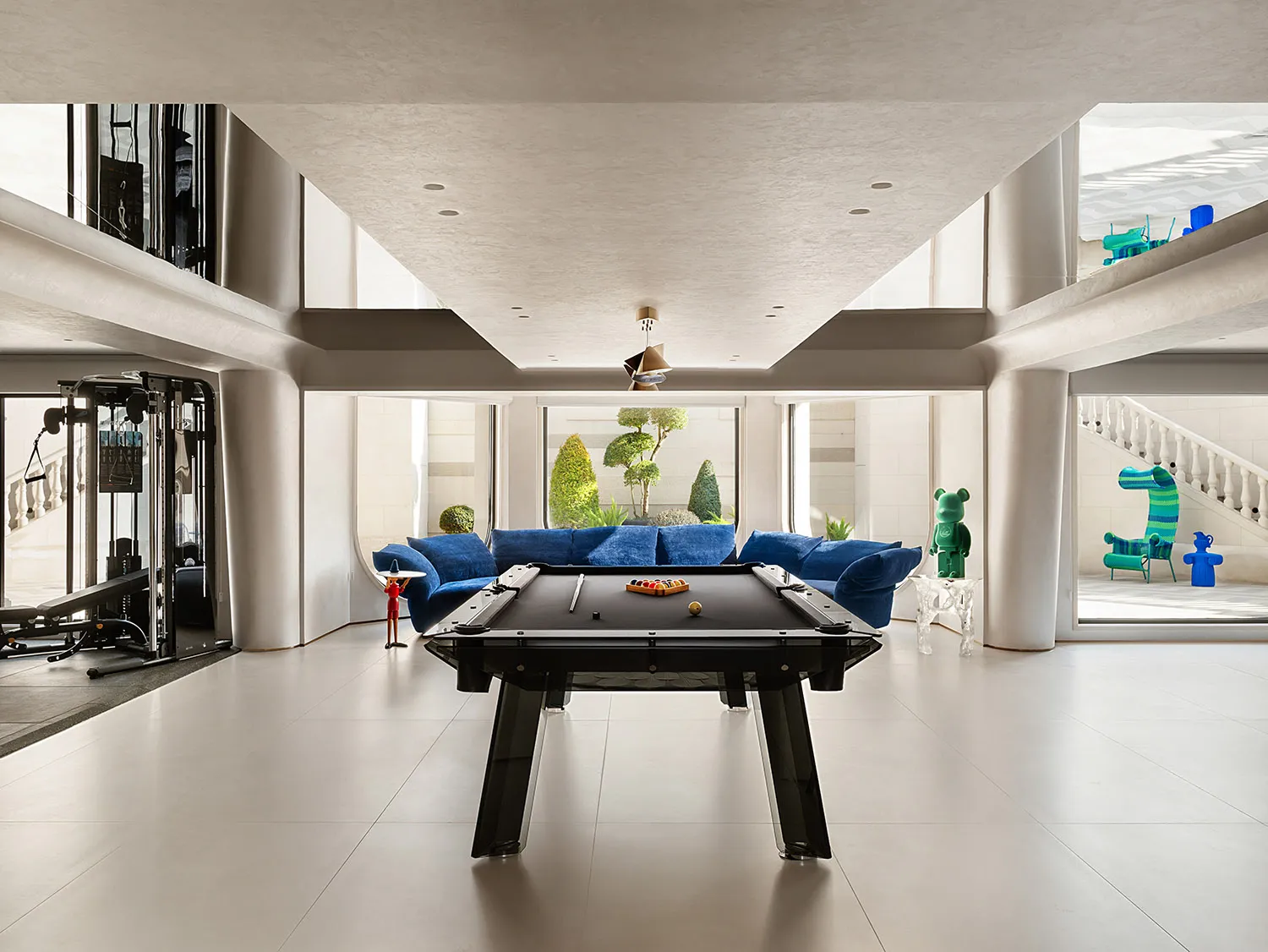A modern living room with glass walls and metal accents.
