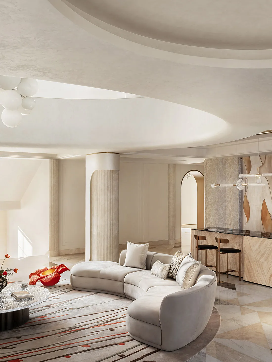 White marble and fabric modern living room with curved sofa and round coffee table.