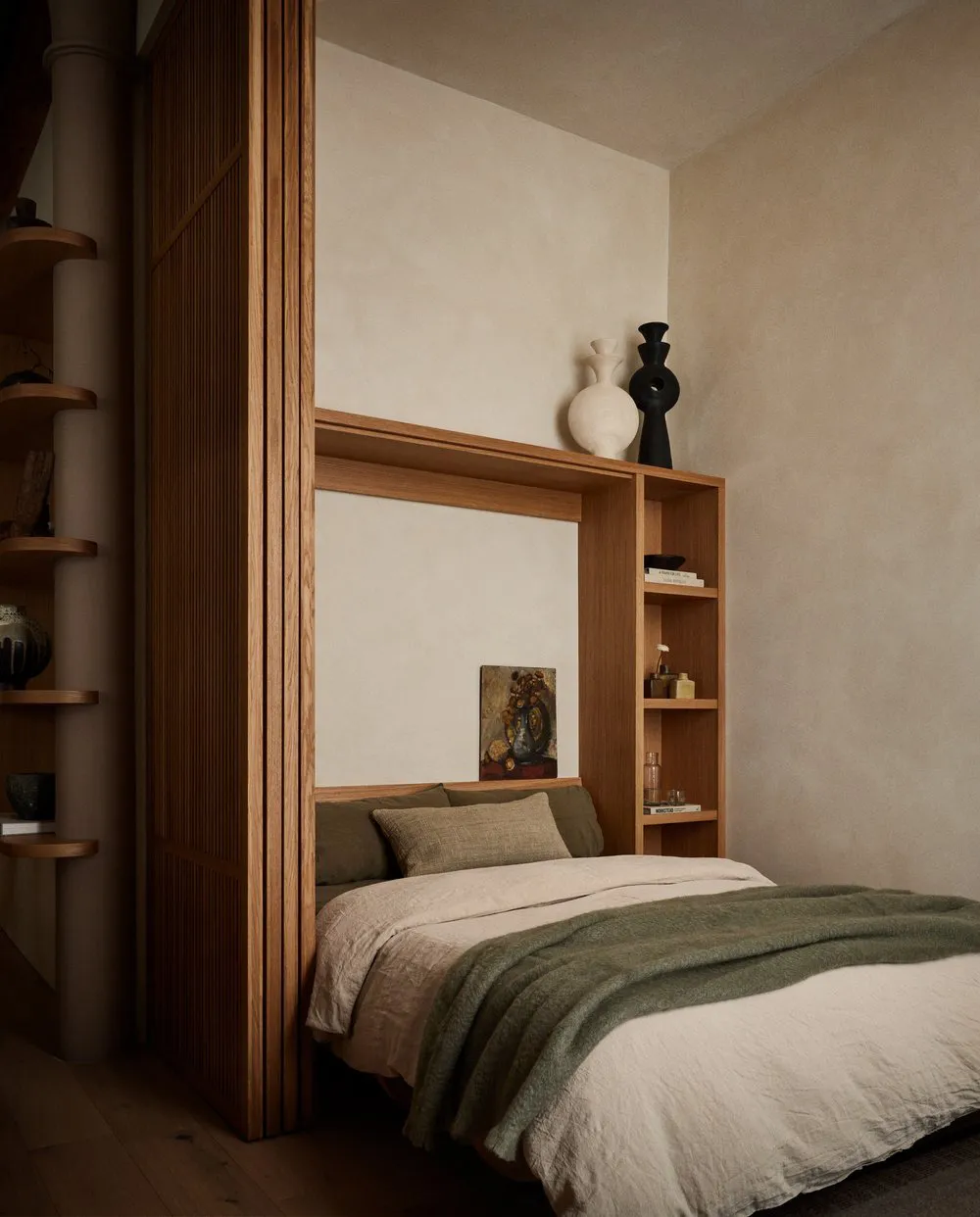 Modern bedroom with wooden wall, shelves, and bed.