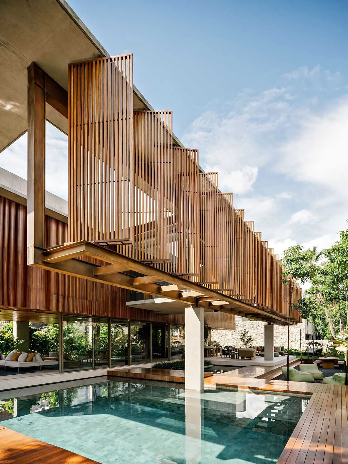 Modern architectural exterior with a wooden structure and a pool.