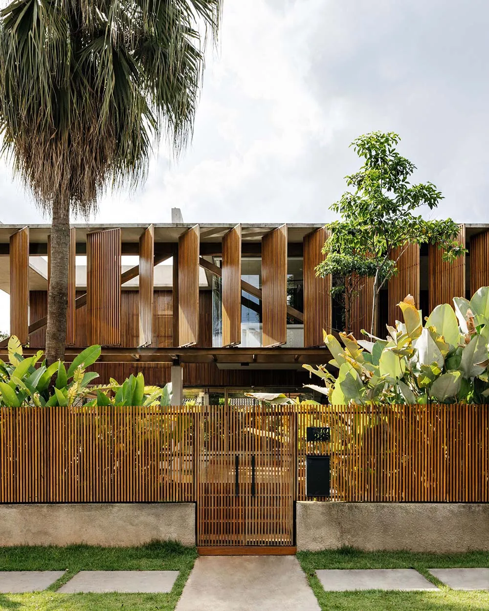 Modern architectural building with wooden exterior and large windows.