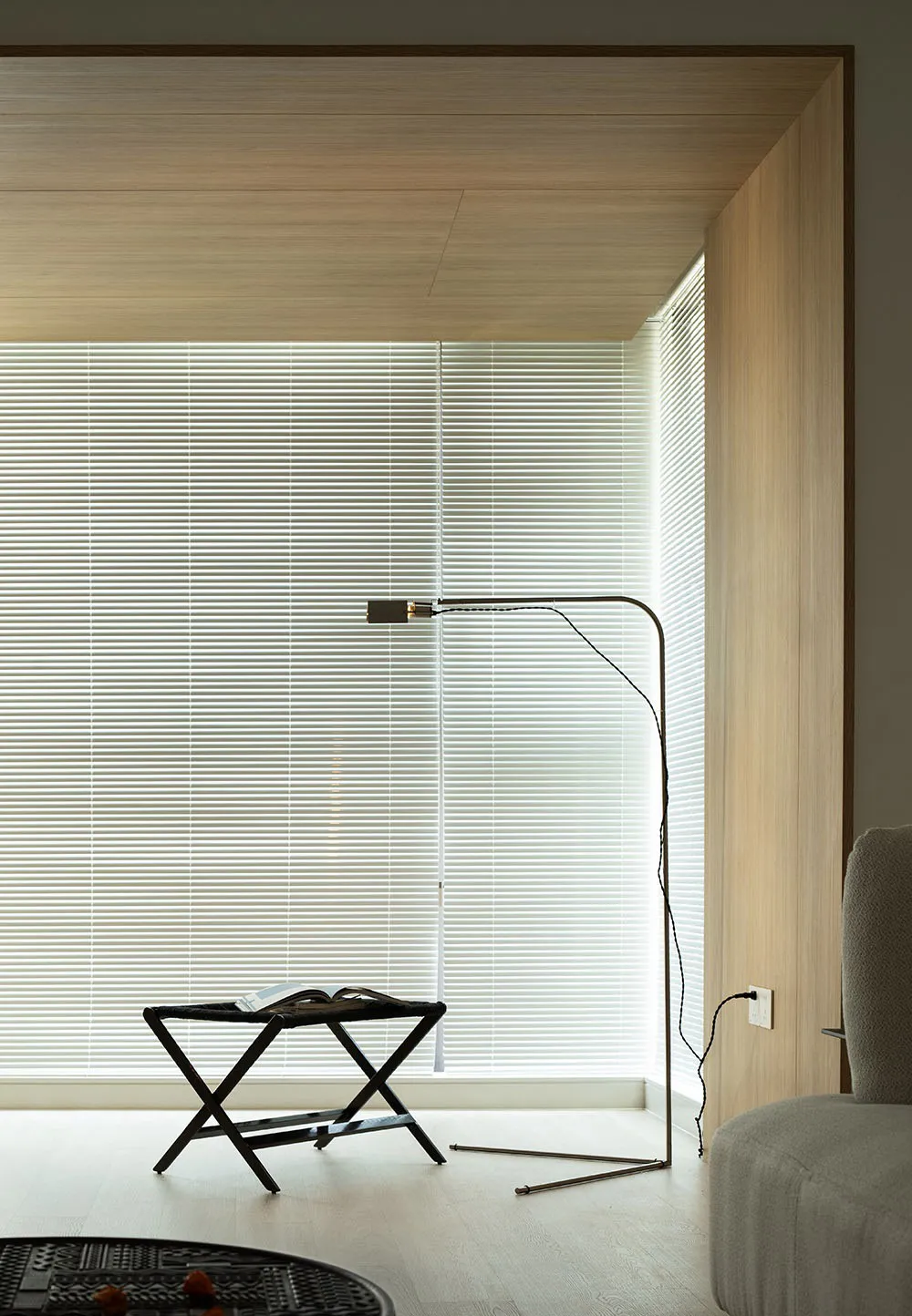 A modern living room featuring minimalist furniture and wooden accents.