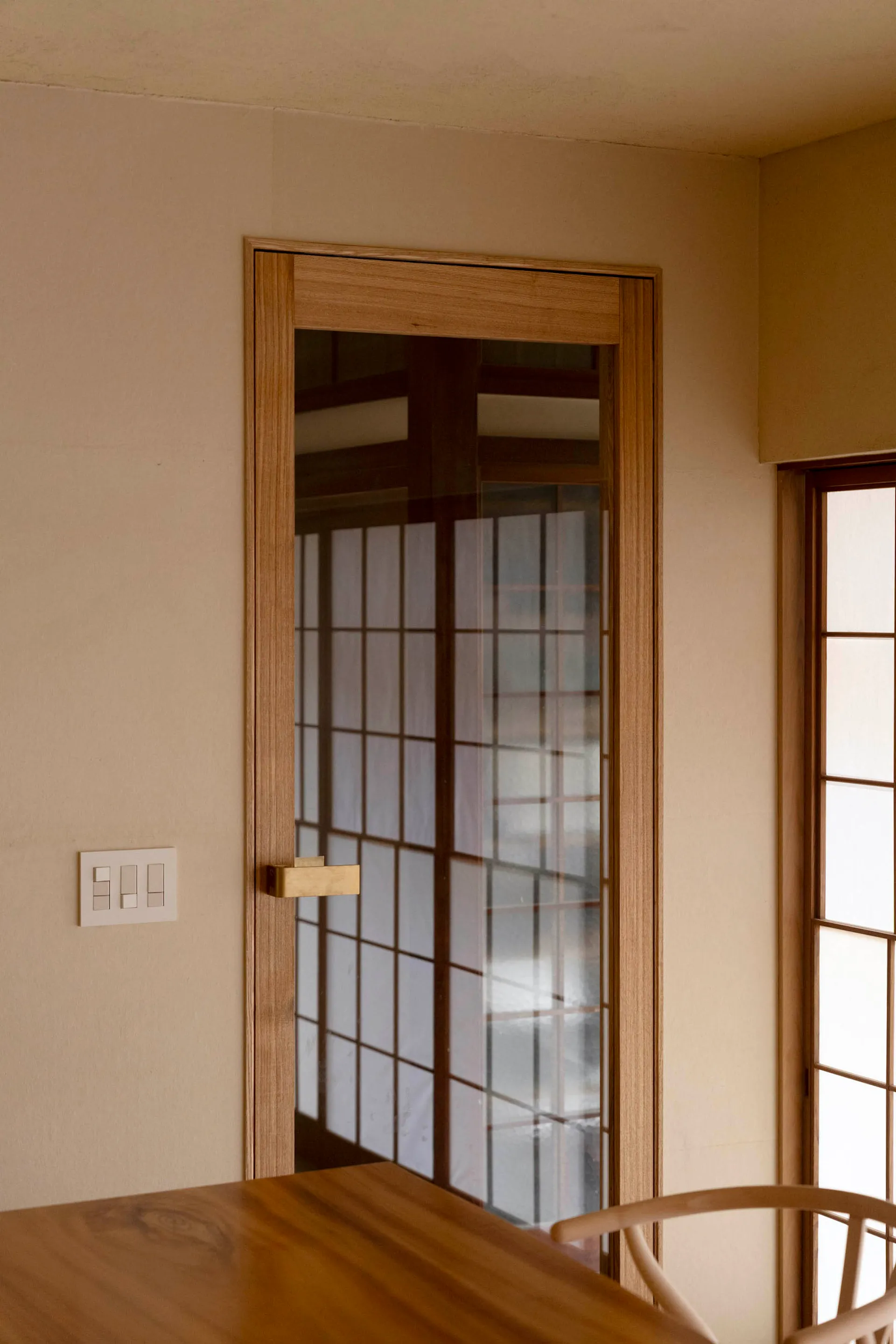 A modern kitchen with a wooden frame and glass door.
