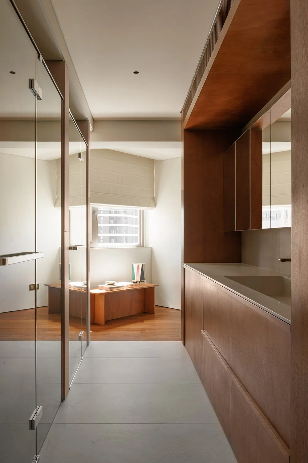 Bright and spacious modern residential kitchen featuring wooden cabinets, a sleek countertop, and a large window allowing nat