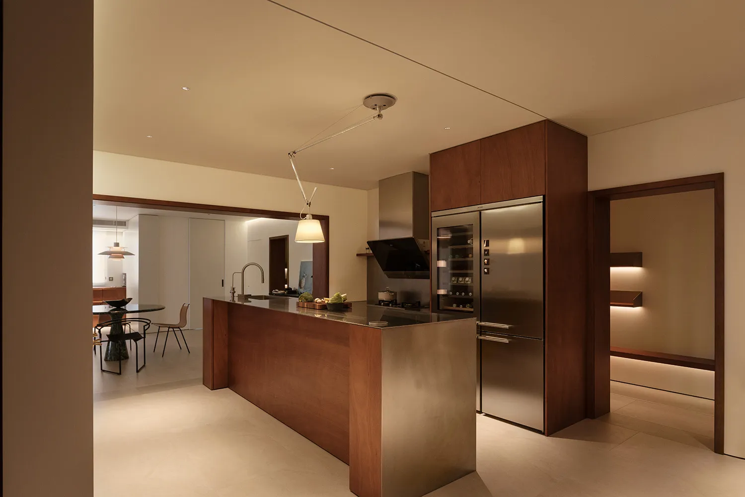 A modern residential kitchen featuring wooden cabinets and stainless steel appliances and countertop.