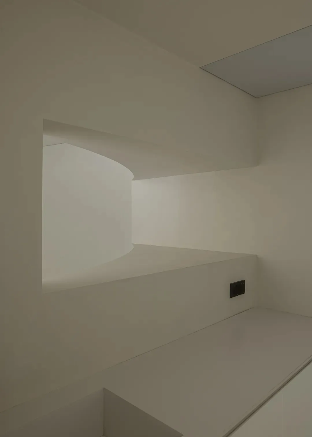 Modern minimalist interior with white plaster staircase