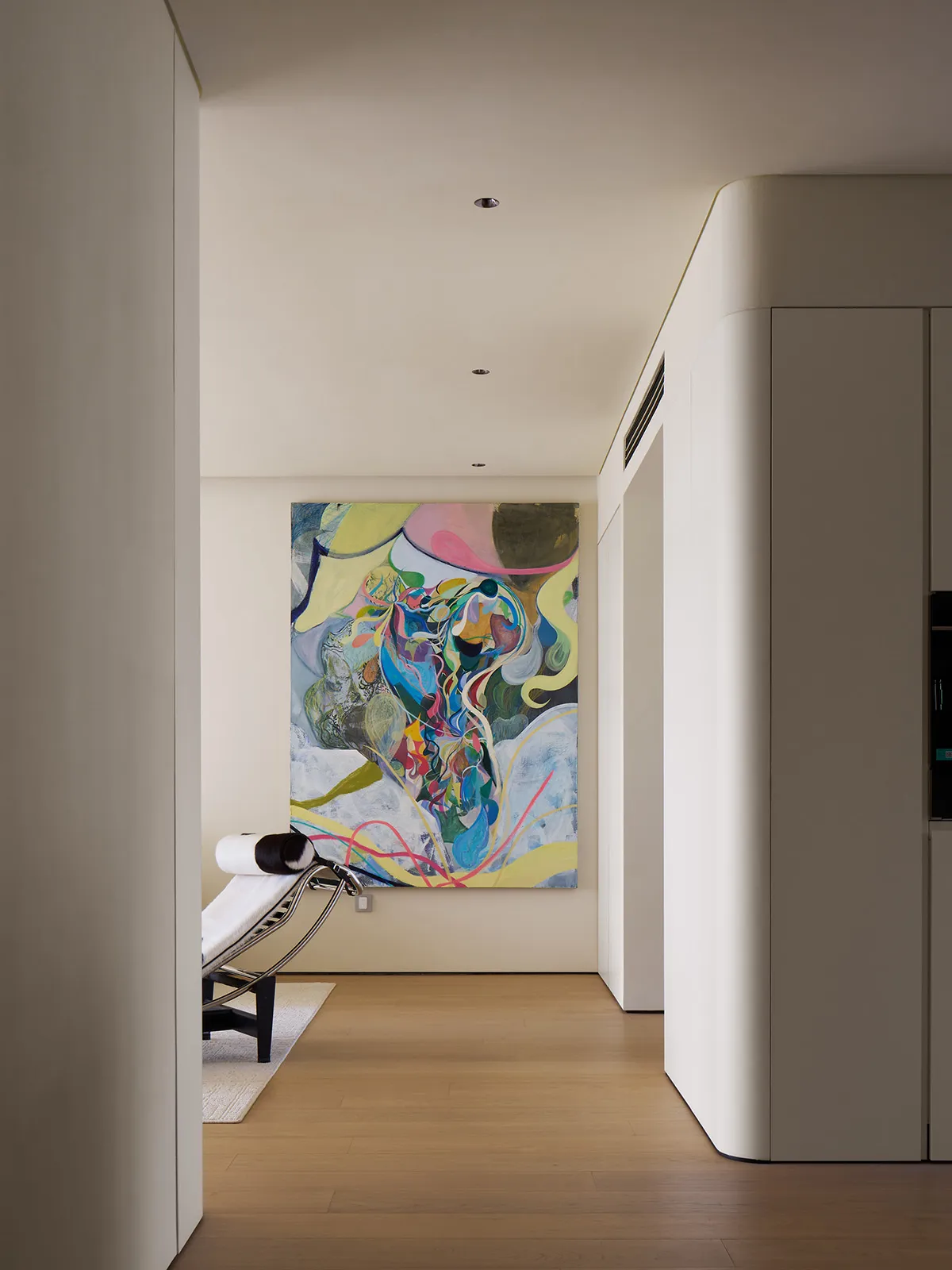 A modern living room featuring a contemporary abstract painting on the wall.