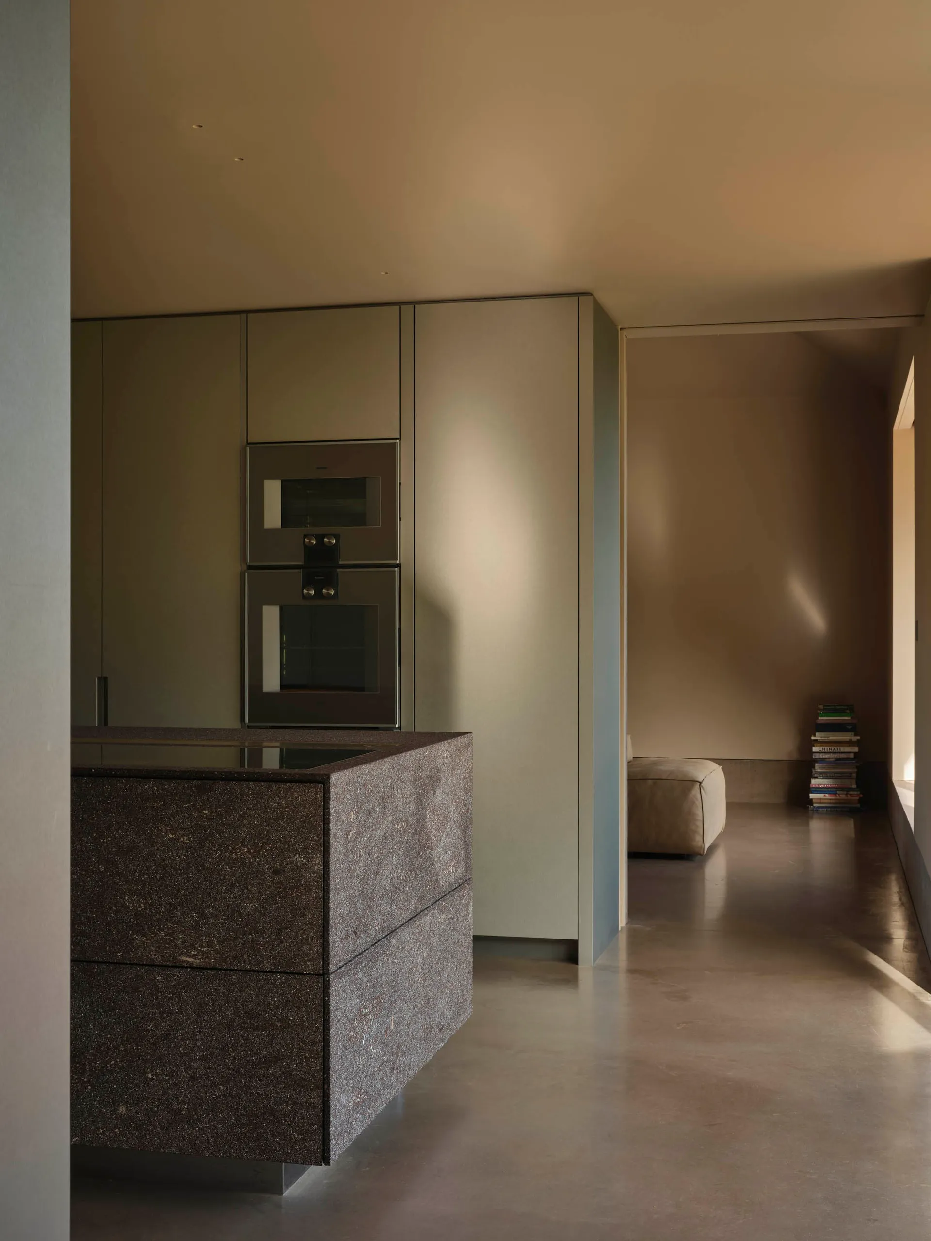 Minimalist kitchen featuring marble countertops and sleek, modern appliances.