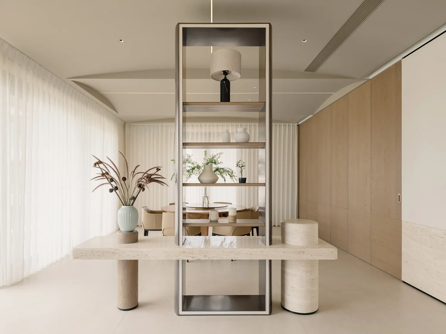 A modern residential kitchen featuring a marble countertop, metal accents, and wooden cabinets.