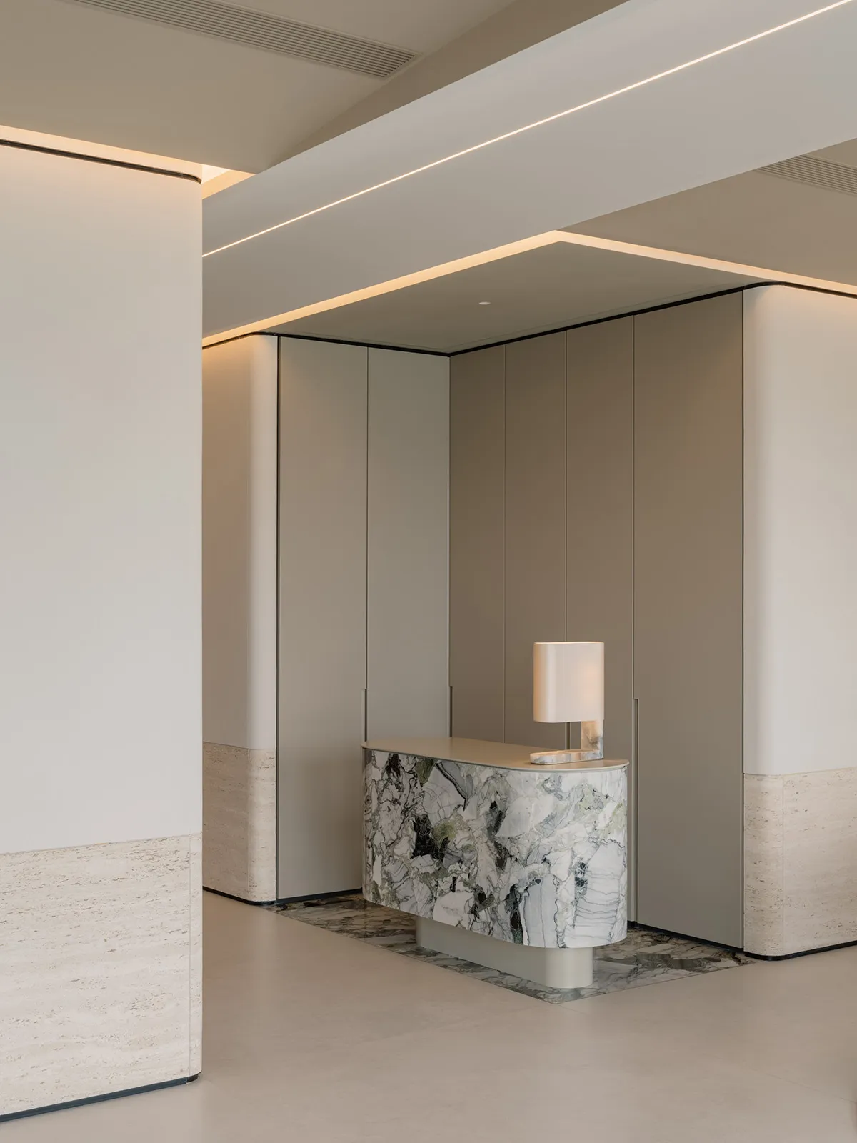 A minimalist lobby with marble accents and a sleek design.