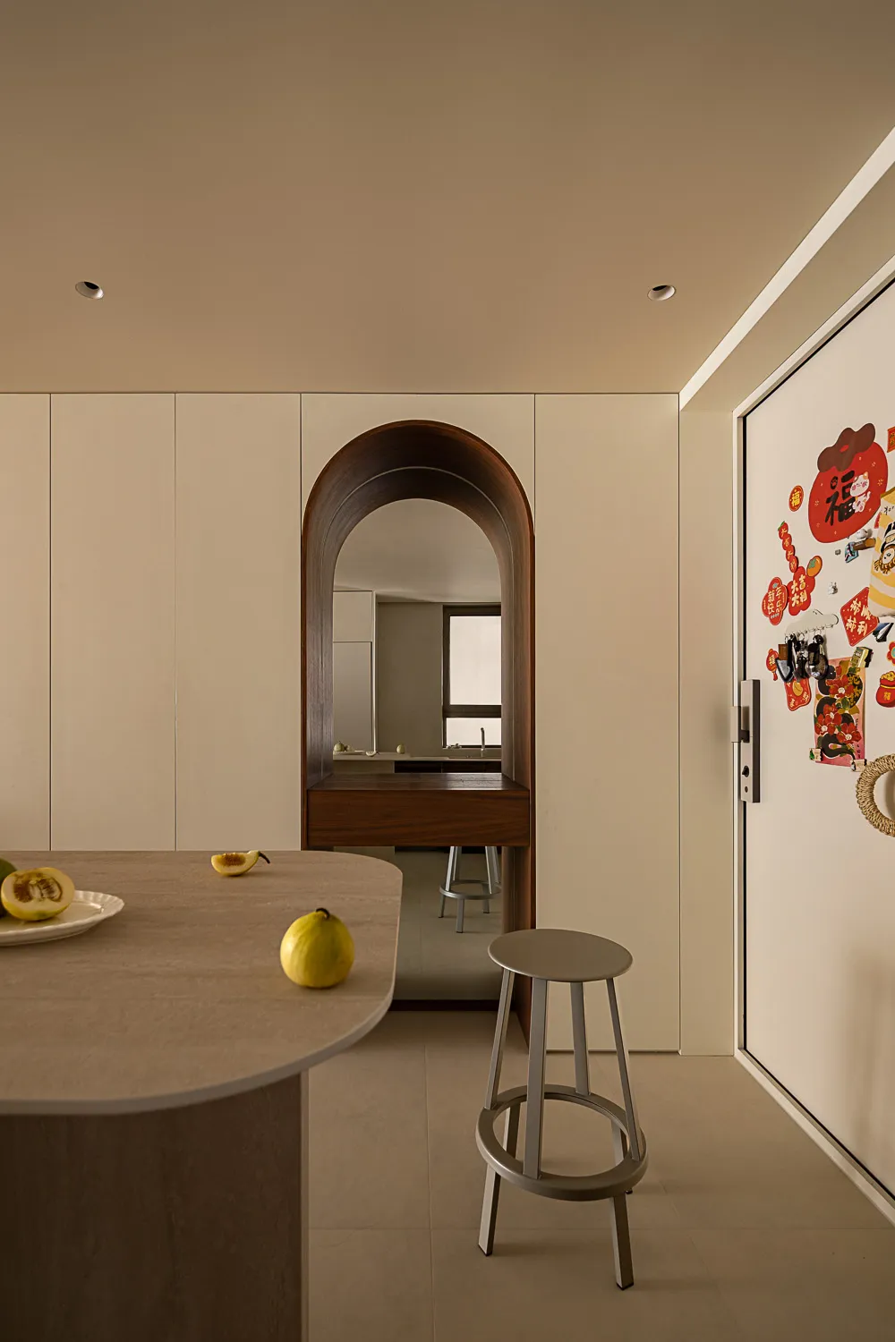 A minimalist kitchen interior with neutral tones and modern design features.