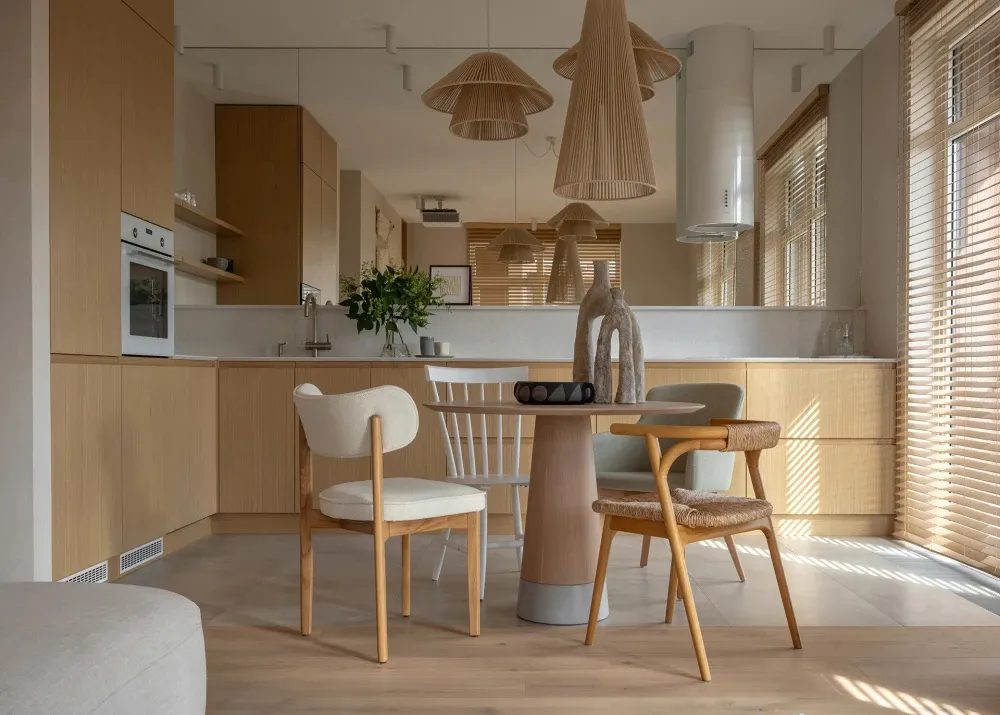 Modern, minimalist residential kitchen featuring wooden cabinets and flooring.