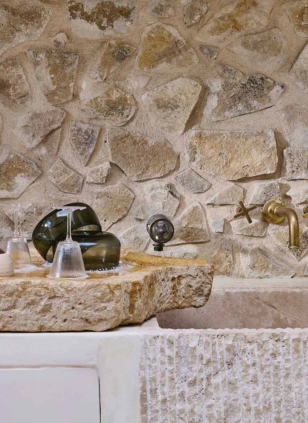 Modern kitchen featuring a stone countertop and brass fixtures.