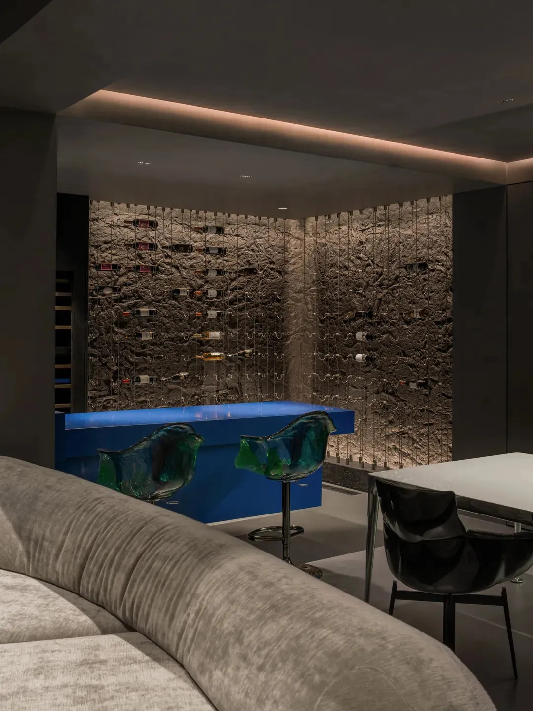 Modern minimalist wine bar with concrete walls and glass bar counter